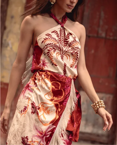 Mujer con top halter estampado y falda pareo de caída envolvente, en un outfit de inspiración mexicana y aire resort para Fiestas Patrias.